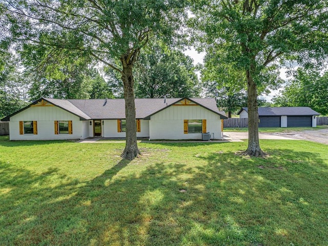 16101 S Rock Creek Rd, Shawnee, OK 74801 - view of front facade featuring a detached garage, board and batten siding, and roof with shingles