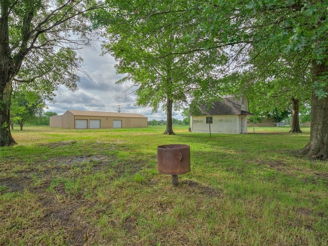 16101 S Rock Creek Rd, Shawnee, OK 74801 - view of green lawn with a detached garage and an outdoor structure