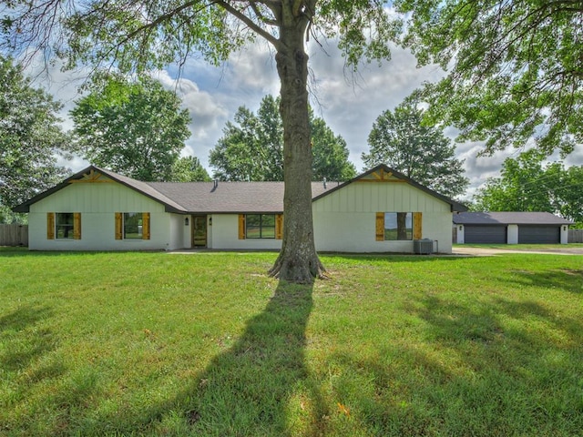 16101 S Rock Creek Rd, Shawnee, OK 74801 - view of front of home with central AC unit, a front lawn, and a garage