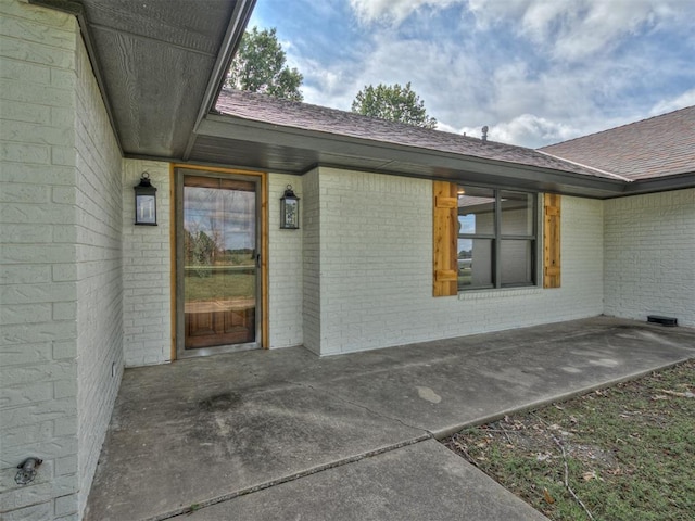 16101 S Rock Creek Rd, Shawnee, OK 74801 - entrance to property featuring brick siding, roof with shingles, and a patio