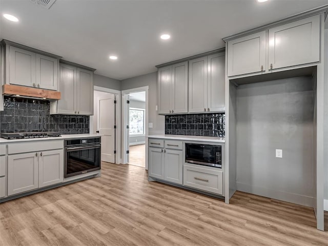 16101 S Rock Creek Rd, Shawnee, OK 74801 - kitchen with black appliances, gray cabinetry, under cabinet range hood, baseboards, and recessed lighting