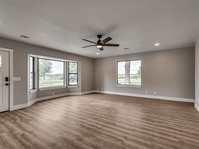 16101 S Rock Creek Rd, Shawnee, OK 74801 - spare room featuring plenty of natural light, wood finished floors, a ceiling fan, and recessed lighting