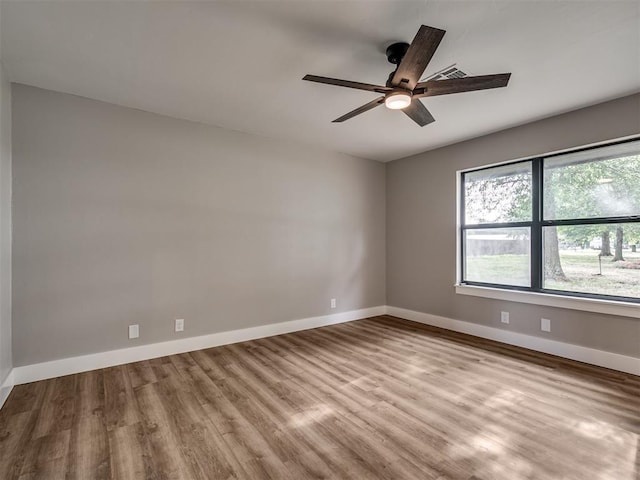 16101 S Rock Creek Rd, Shawnee, OK 74801 - unfurnished room with a ceiling fan, wood finished floors, and baseboards