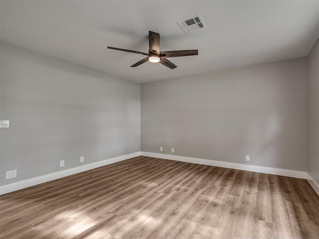 16101 S Rock Creek Rd, Shawnee, OK 74801 - unfurnished room with a ceiling fan, wood finished floors, and baseboards