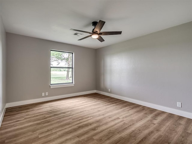 16101 S Rock Creek Rd, Shawnee, OK 74801 - spare room featuring ceiling fan, wood finished floors, and baseboards