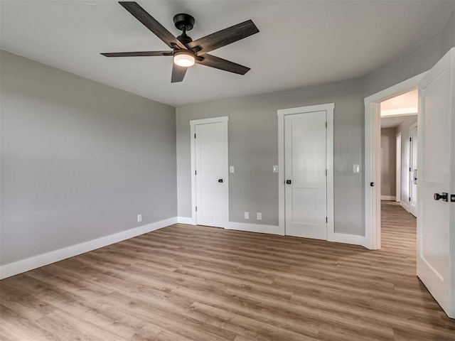 16101 S Rock Creek Rd, Shawnee, OK 74801 - unfurnished bedroom featuring wood finished floors, baseboards, and ceiling fan