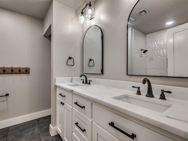 16101 S Rock Creek Rd, Shawnee, OK 74801 - bathroom featuring double vanity, baseboards, and tiled shower