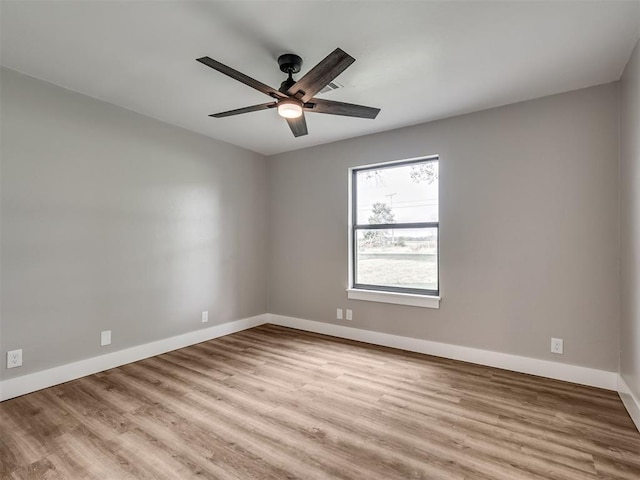 16101 S Rock Creek Rd, Shawnee, OK 74801 - spare room with a ceiling fan, baseboards, and wood finished floors