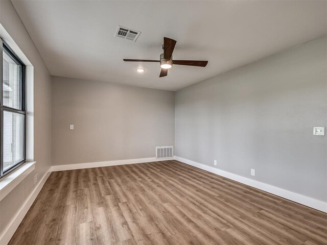 16101 S Rock Creek Rd, Shawnee, OK 74801 - unfurnished room with wood finished floors, ceiling fan, and baseboards