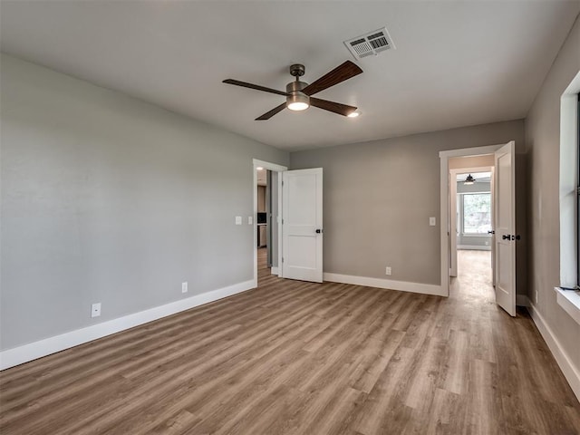 16101 S Rock Creek Rd, Shawnee, OK 74801 - unfurnished bedroom featuring wood finished floors, baseboards, and a ceiling fan