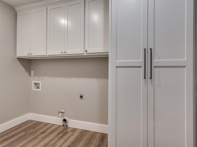 16101 S Rock Creek Rd, Shawnee, OK 74801 - laundry room featuring baseboards, wood finished floors, cabinet space, hookup for an electric dryer, and hookup for a gas dryer