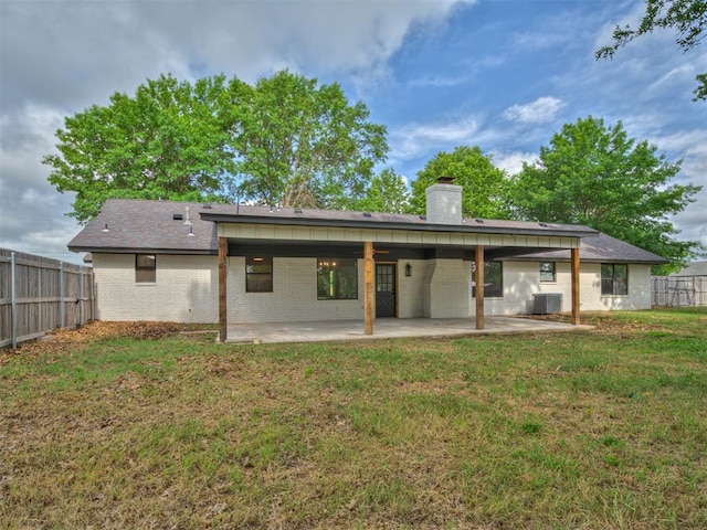 16101 S Rock Creek Rd, Shawnee, OK 74801 - rear view of property with central AC unit, a chimney, brick siding, and a patio