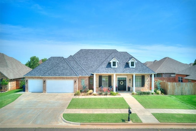 6005 NW 155th St, Edmond, OK 73013 - view of front of home featuring an attached garage, concrete driveway, covered porch, brick siding, and roof with shingles