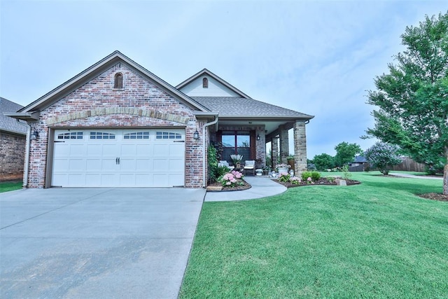 3434 Crampton Gap Way, Norman, OK 73069 - view of front of home with a front yard, driveway, an attached garage, brick siding, and a porch