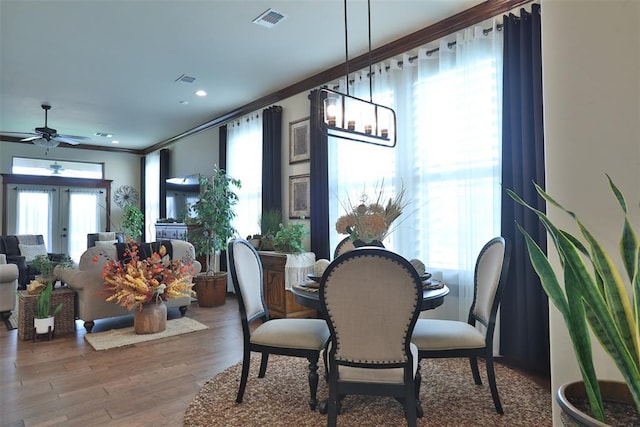 3434 Crampton Gap Way, Norman, OK 73069 - dining space featuring crown molding, plenty of natural light, wood finished floors, and a ceiling fan