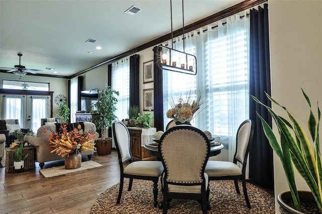 3434 Crampton Gap Way, Norman, OK 73069 - dining area with ornamental molding, a ceiling fan, and wood finished floors
