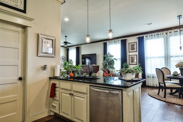 3434 Crampton Gap Way, Norman, OK 73069 - kitchen featuring stainless steel dishwasher, dark countertops, cream cabinetry, a ceiling fan, and open floor plan