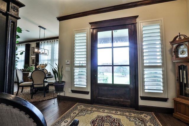 3434 Crampton Gap Way, Norman, OK 73069 - foyer with ornamental molding, dark wood-style flooring, and a chandelier