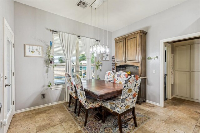 2913 Elmo Way, Oklahoma City, OK 73160 - dining room featuring light stone finish floors and baseboards