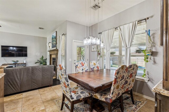 2913 Elmo Way, Oklahoma City, OK 73160 - dining room featuring plenty of natural light, a fireplace, and baseboards