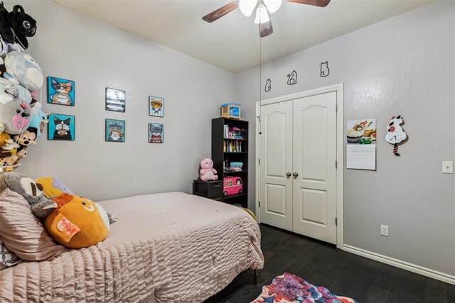 2913 Elmo Way, Oklahoma City, OK 73160 - bedroom featuring dark wood-style floors, a closet, baseboards, and ceiling fan