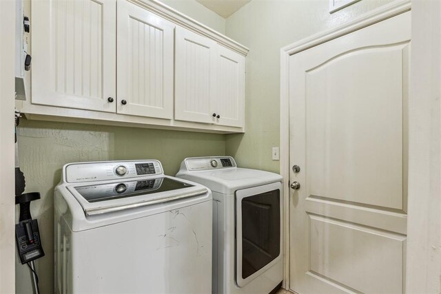 2913 Elmo Way, Oklahoma City, OK 73160 - laundry area featuring washing machine and dryer and cabinet space