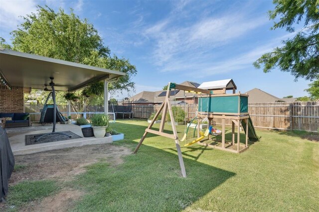 2913 Elmo Way, Oklahoma City, OK 73160 - view of yard with a playground, a trampoline, and a patio