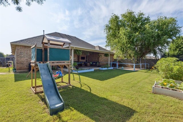2913 Elmo Way, Oklahoma City, OK 73160 - view of yard with a playground, a vegetable garden, outdoor lounge area, and a patio area