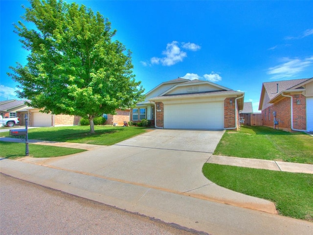 724 Ga Zump Dr, Norman, OK 73069 - view of front of property with an attached garage, brick siding, and driveway