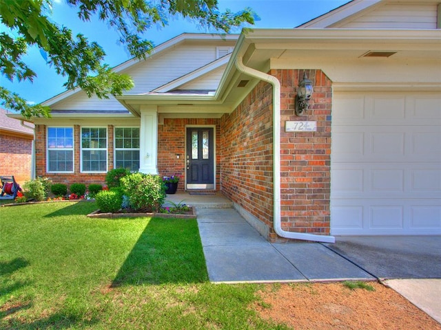724 Ga Zump Dr, Norman, OK 73069 - doorway to property featuring an attached garage, brick siding, and a yard