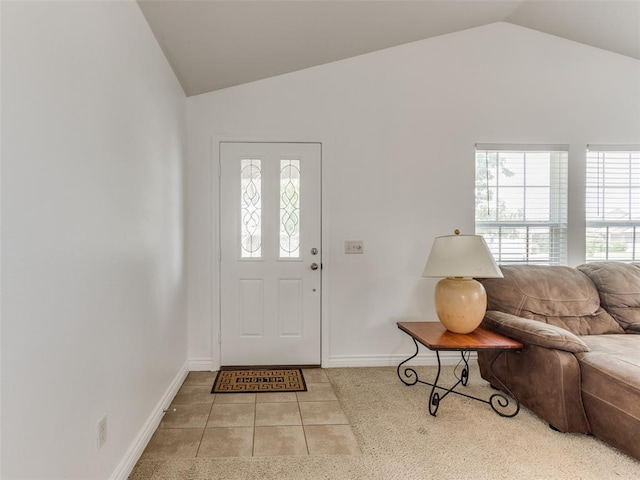 724 Ga Zump Dr, Norman, OK 73069 - entryway featuring lofted ceiling, plenty of natural light, baseboards, and tile patterned flooring