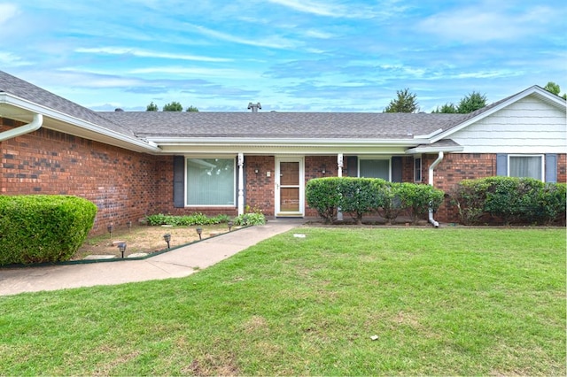 3860 Wake Forest Rd, Edmond, OK 73034 - ranch-style home featuring brick siding, a front yard, and a shingled roof