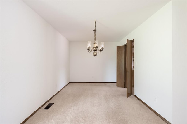 3860 Wake Forest Rd, Edmond, OK 73034 - unfurnished room featuring a chandelier and light carpet