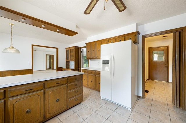 3860 Wake Forest Rd, Edmond, OK 73034 - kitchen featuring white refrigerator with ice dispenser, ceiling fan, brown cabinets, light countertops, and light tile patterned flooring