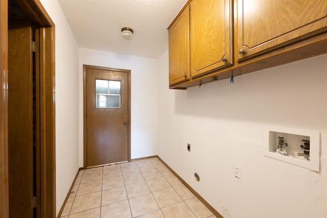 3860 Wake Forest Rd, Edmond, OK 73034 - washroom with cabinet space, washer hookup, light tile patterned floors, electric dryer hookup, and a textured ceiling