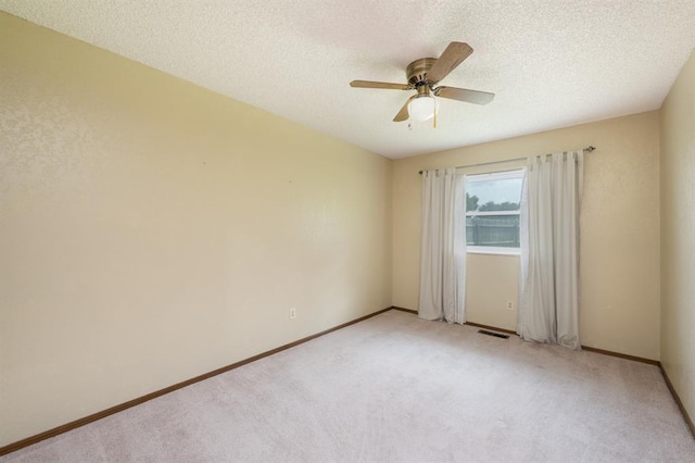 3860 Wake Forest Rd, Edmond, OK 73034 - unfurnished room featuring ceiling fan, light carpet, and a textured ceiling