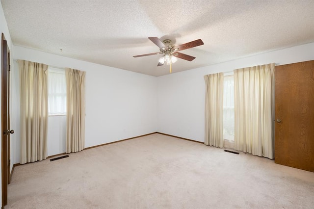3860 Wake Forest Rd, Edmond, OK 73034 - unfurnished room with light carpet, ceiling fan, and a textured ceiling