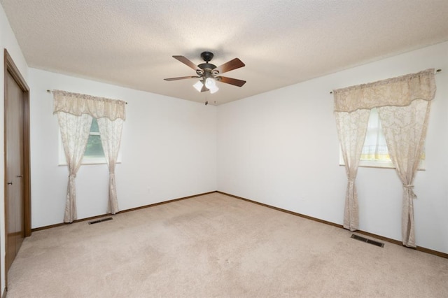 3860 Wake Forest Rd, Edmond, OK 73034 - unfurnished bedroom featuring light carpet, a closet, ceiling fan, and a textured ceiling