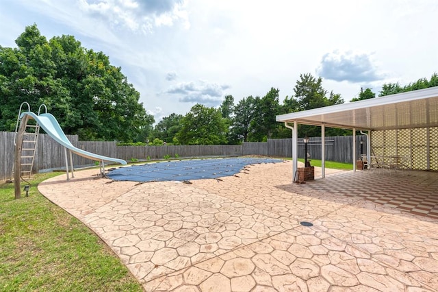 3860 Wake Forest Rd, Edmond, OK 73034 - view of pool featuring a water slide, a patio area, and a fenced backyard