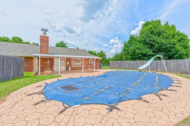 3860 Wake Forest Rd, Edmond, OK 73034 - view of pool with a fenced backyard, a patio area, and a water slide
