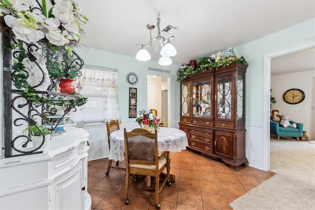 4912 NW 29th St, Oklahoma City, OK 73127 - dining room featuring light tile patterned floors and a chandelier