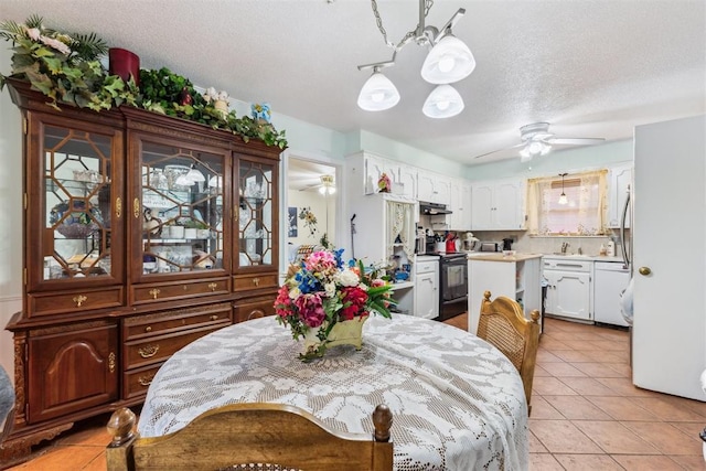 4912 NW 29th St, Oklahoma City, OK 73127 - dining space featuring a ceiling fan, a chandelier, light tile patterned floors, and a textured ceiling