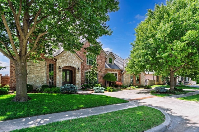 412 Flint Ridge Ct, Norman, OK 73072 - view of front facade with stone siding and a front lawn