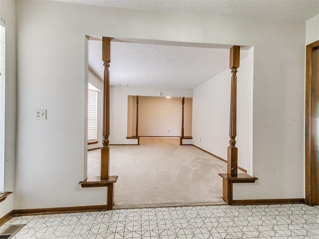 5201 SE 53rd St, Oklahoma City, OK 73135 - unfurnished room featuring a textured ceiling, baseboards, and light carpet