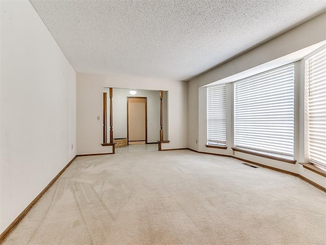 5201 SE 53rd St, Oklahoma City, OK 73135 - unfurnished room featuring carpet flooring, baseboards, plenty of natural light, and a textured ceiling