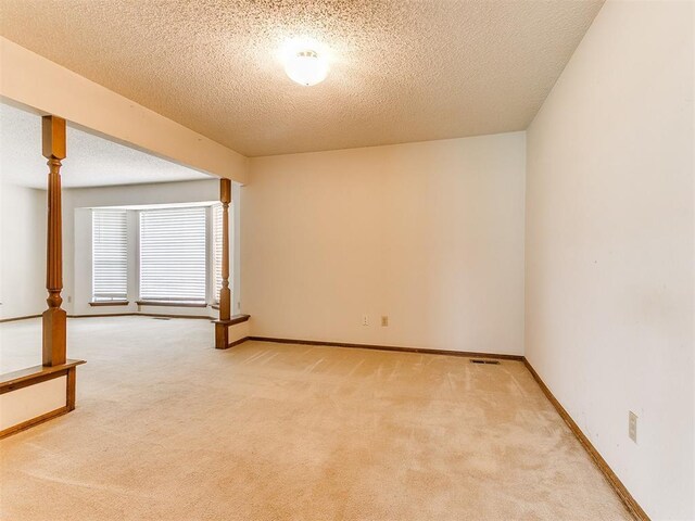 5201 SE 53rd St, Oklahoma City, OK 73135 - unfurnished room featuring a textured ceiling, light carpet, and baseboards