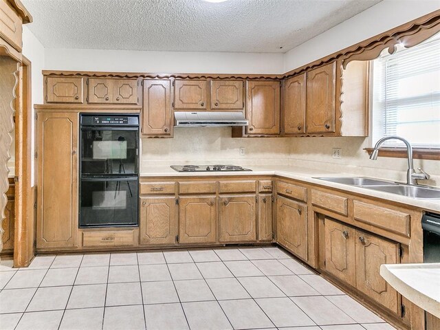 5201 SE 53rd St, Oklahoma City, OK 73135 - kitchen with a sink, under cabinet range hood, gas cooktop, a textured ceiling, and light countertops