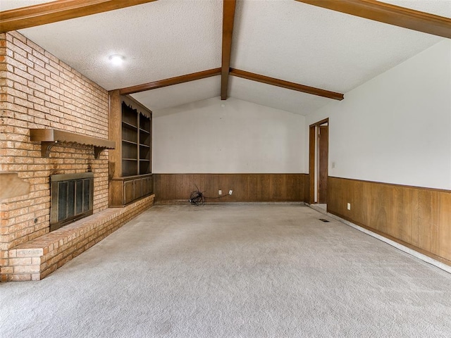5201 SE 53rd St, Oklahoma City, OK 73135 - unfurnished living room with wainscoting, wood walls, carpet floors, built in shelves, and a brick fireplace