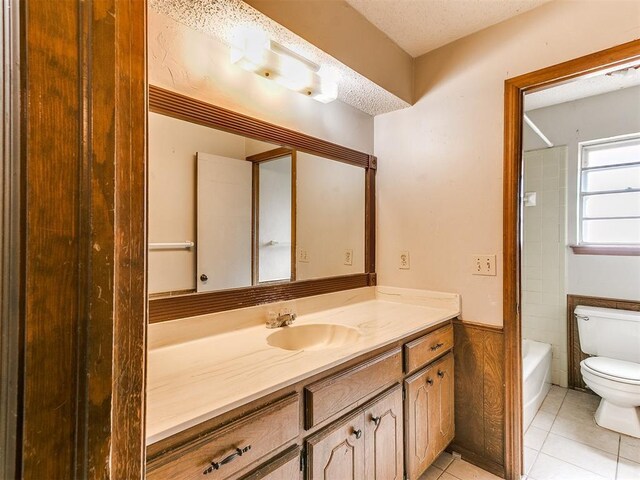 5201 SE 53rd St, Oklahoma City, OK 73135 - full bath featuring toilet, vanity, tile patterned floors, shower / bath combination, and a textured ceiling