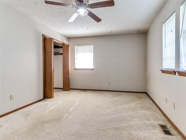 5201 SE 53rd St, Oklahoma City, OK 73135 - unfurnished bedroom featuring a textured ceiling, light colored carpet, a ceiling fan, and a closet